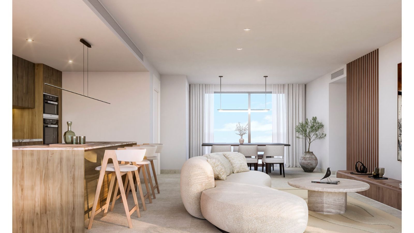 Modern öppen planlösning med kök och matplats.